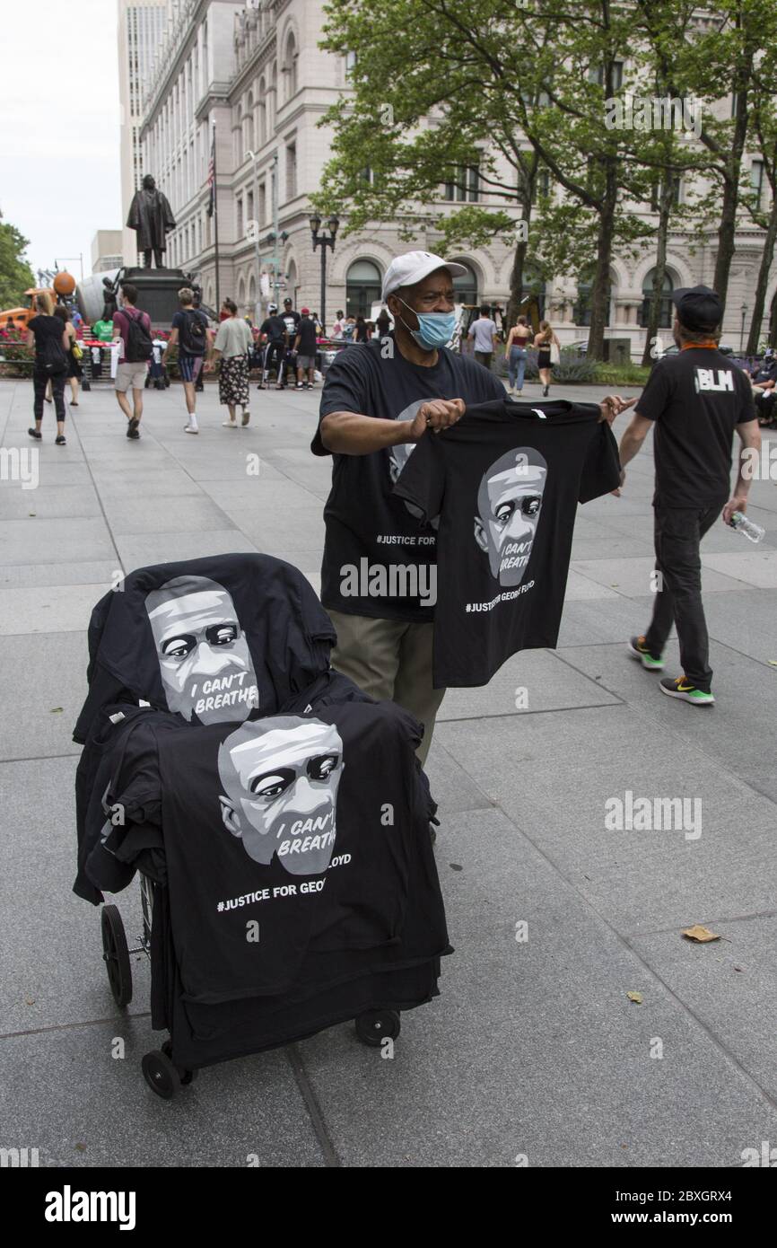 Memorial gathering and demonstration honoring George Floyd at Cadman Plaza in Brooklyn who was murdered by Minneapolis police. Man sells George Floyd t-shirts near the memorial demonstrtion. Stock Photo