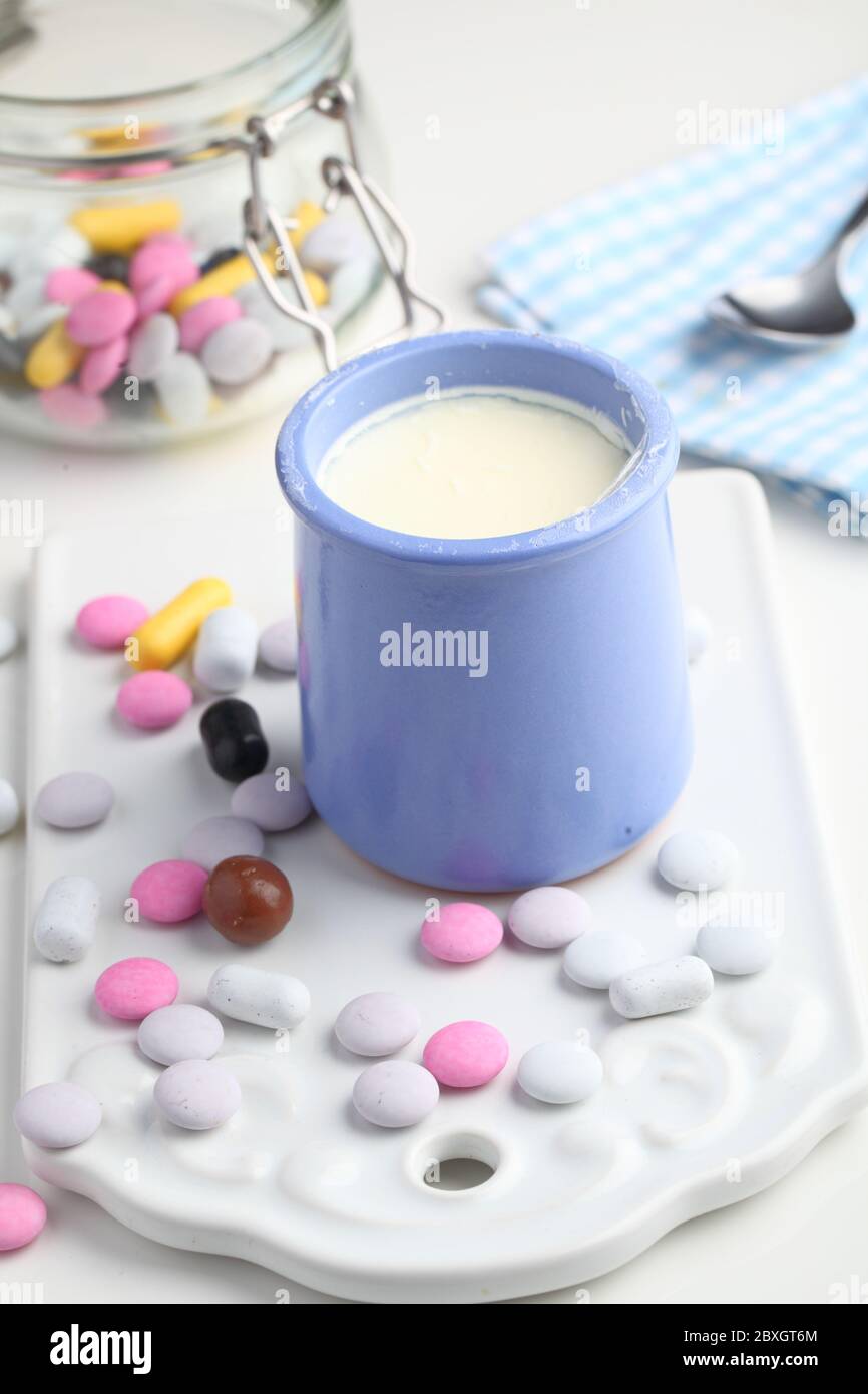 Jar of vanilla yogurt and candies Stock Photo Alamy