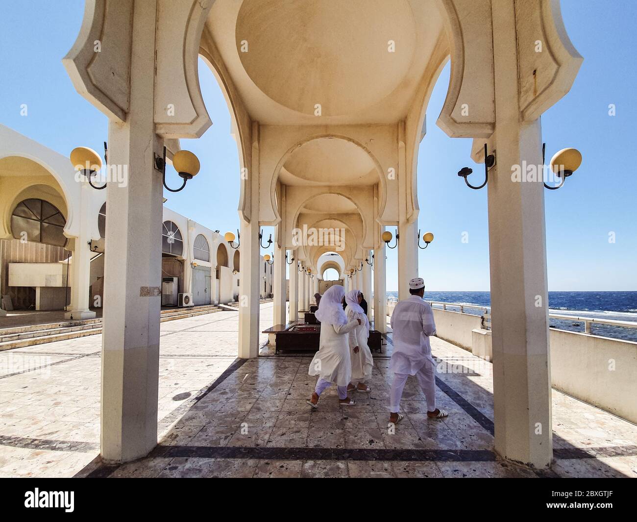 Jeddah / Saudi Arabia - January 20, 2020: Beautiful Mosque near the sea with arches and columns and believers praying Stock Photo