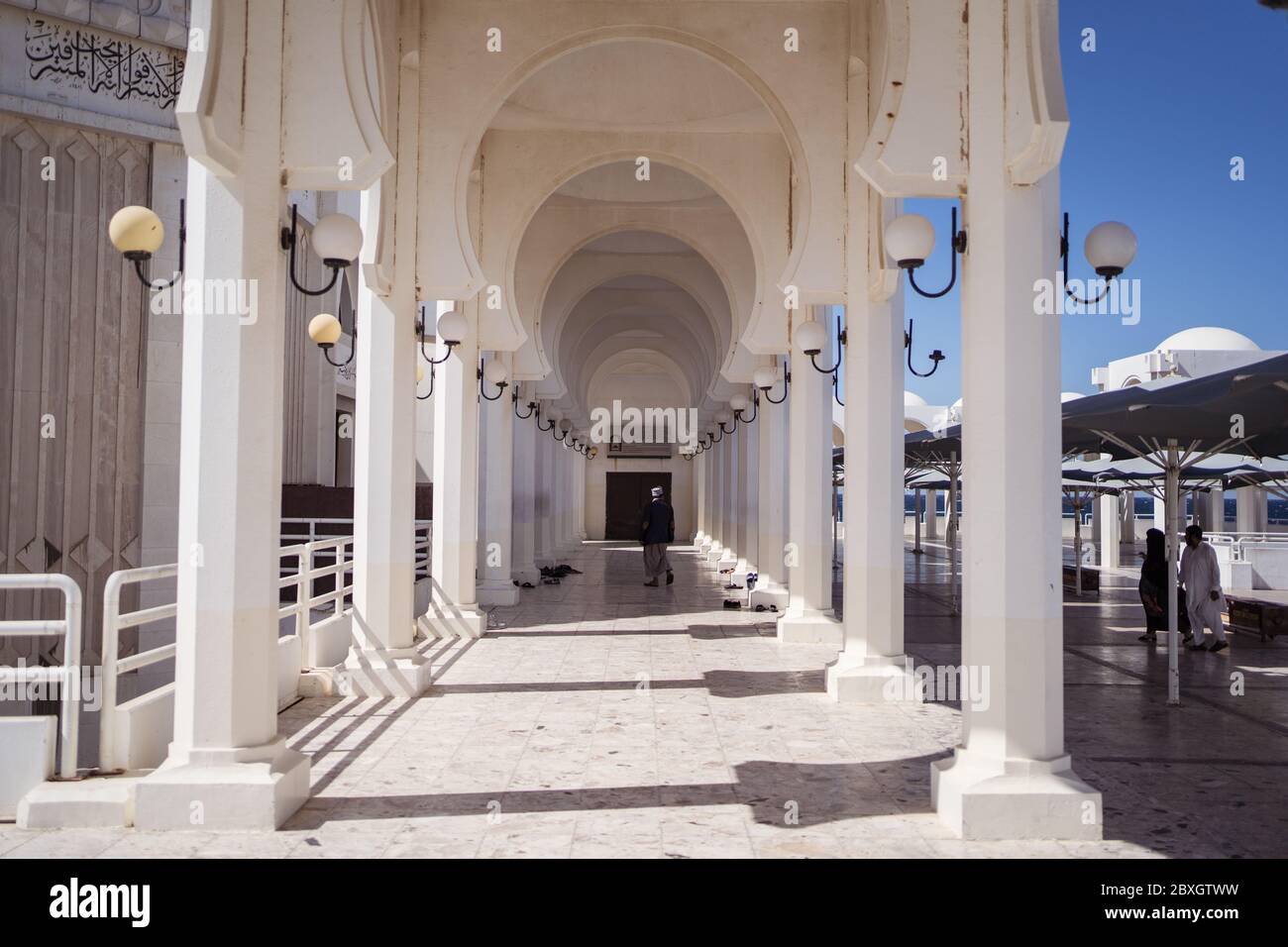 Jeddah / Saudi Arabia - January 20, 2020: Beautiful Mosque near the sea with arches and columns and believers praying Stock Photo