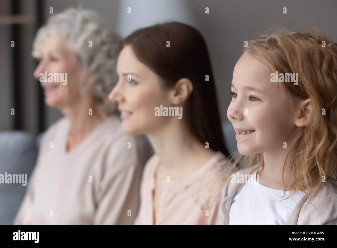Profile view of three generations of woman dreaming at home Stock Photo