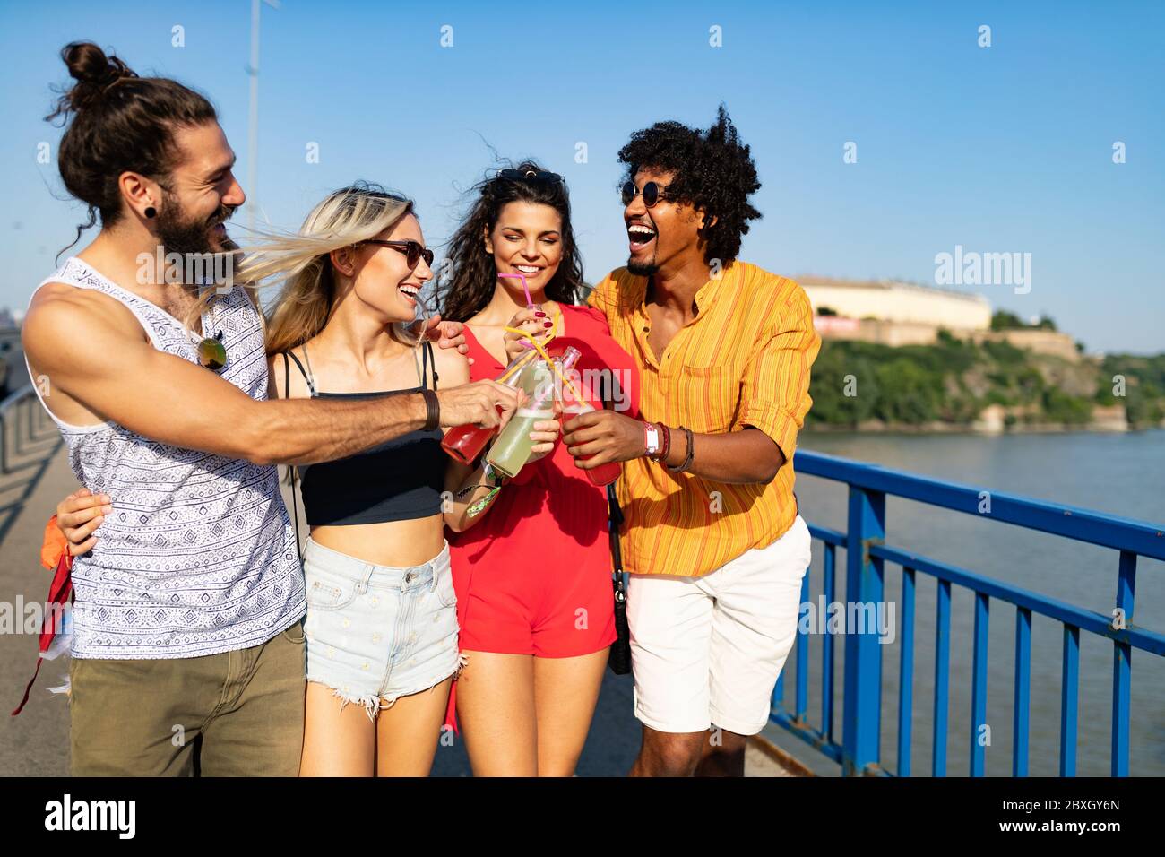 Group of friends having fun and hanging out outdoors Stock Photo