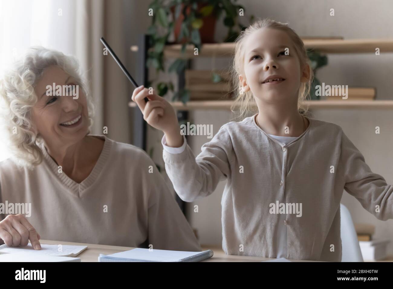 Funny little girl have fun studying at home Stock Photo - Alamy