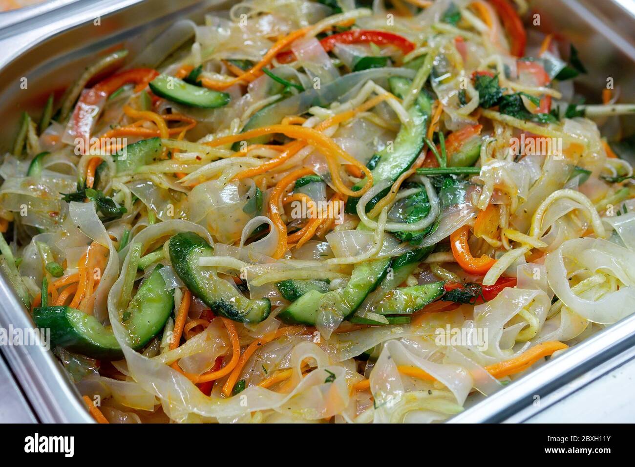 Ashlyamfu,starch noodles, dishes national dish of the Uighur cuisine. sale of a ready-made dish on the market. Stock Photo