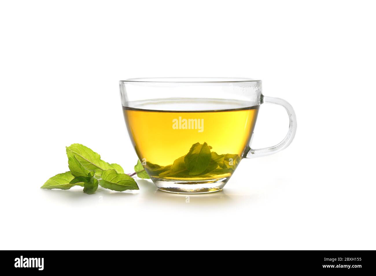 herbal tea made from fresh peppermint leaves in a glass cup isolated on a white background, copy space Stock Photo