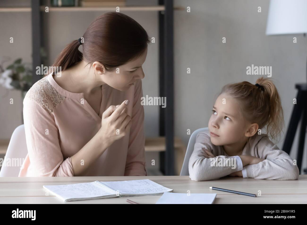 Strict mother scold schoolgirl daughter for bad marks Stock Photo