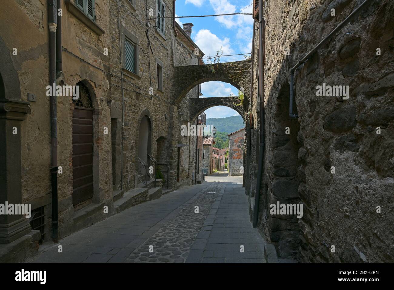 Narrow alley in Virgoletta, a beautiful ancient mountain village, empty during coronavirus pandemic, district of Villafranca in Lunigiana, Tuscany, It Stock Photo