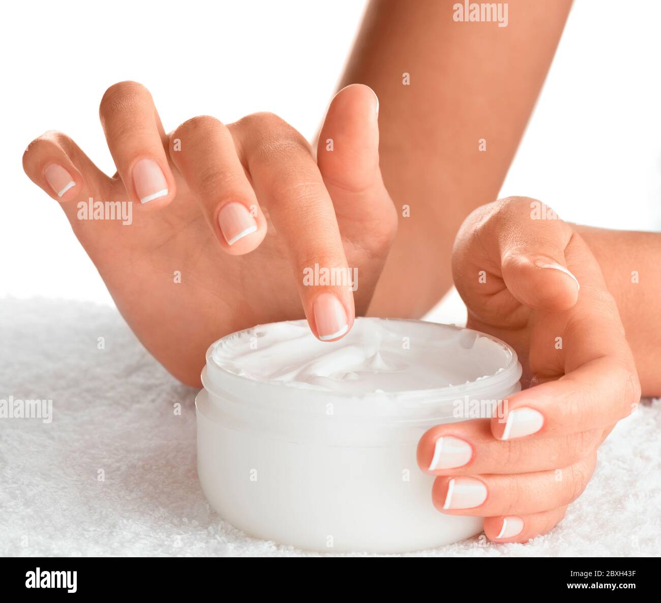 Female finger in a pot of hand cream Stock Photo Alamy