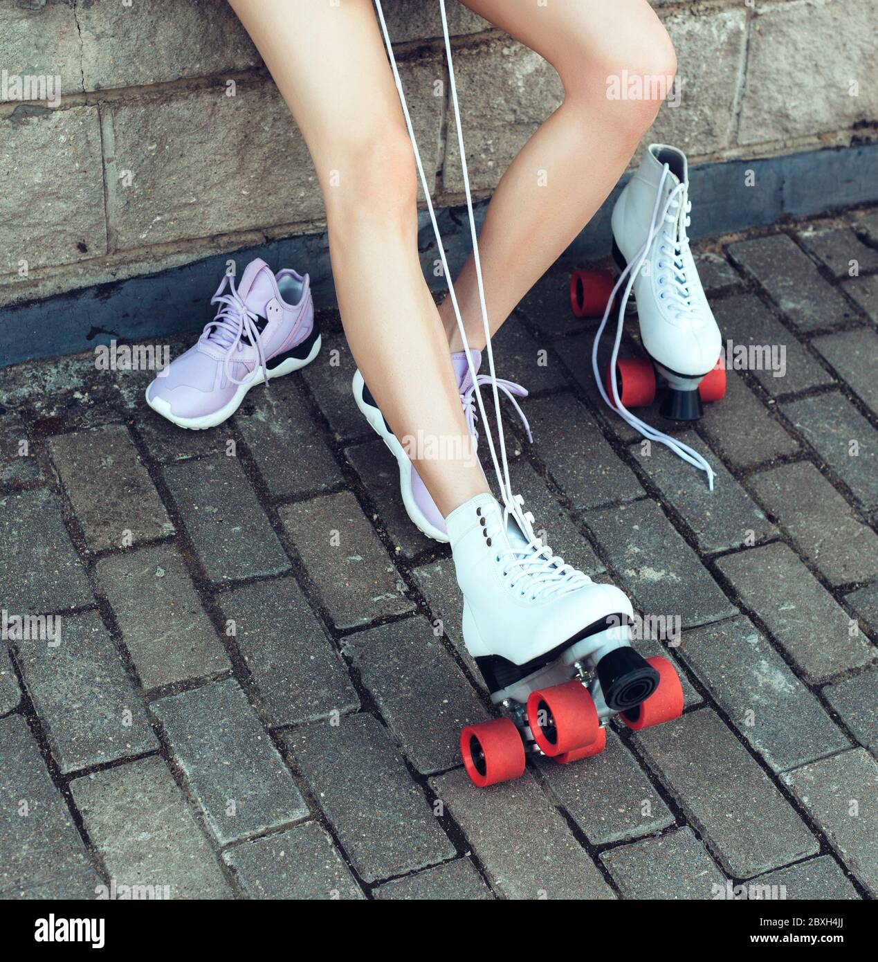 Girl changing into roller skates Stock Photo Alamy