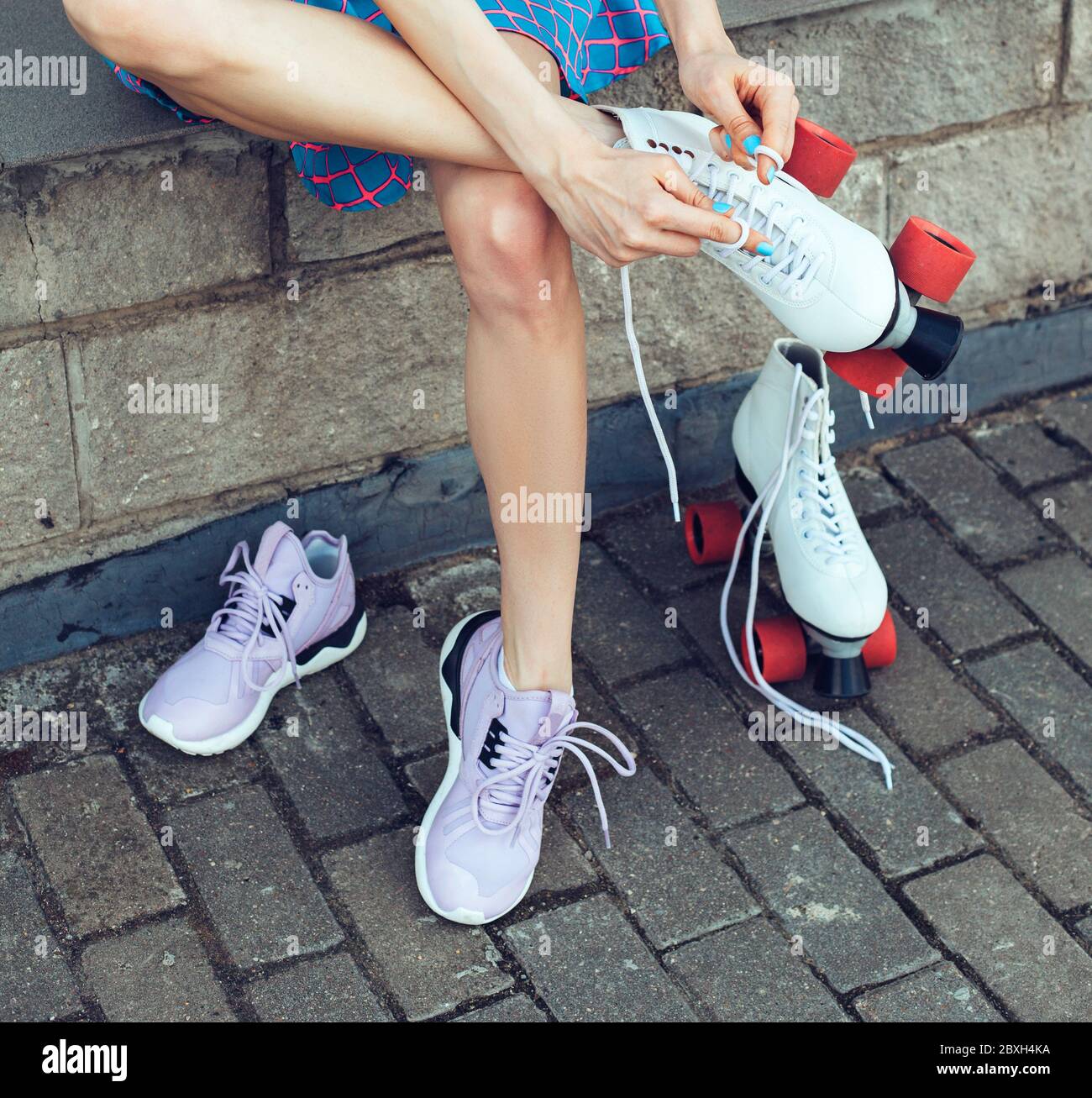 Girl changing into roller skates Stock Photo Alamy