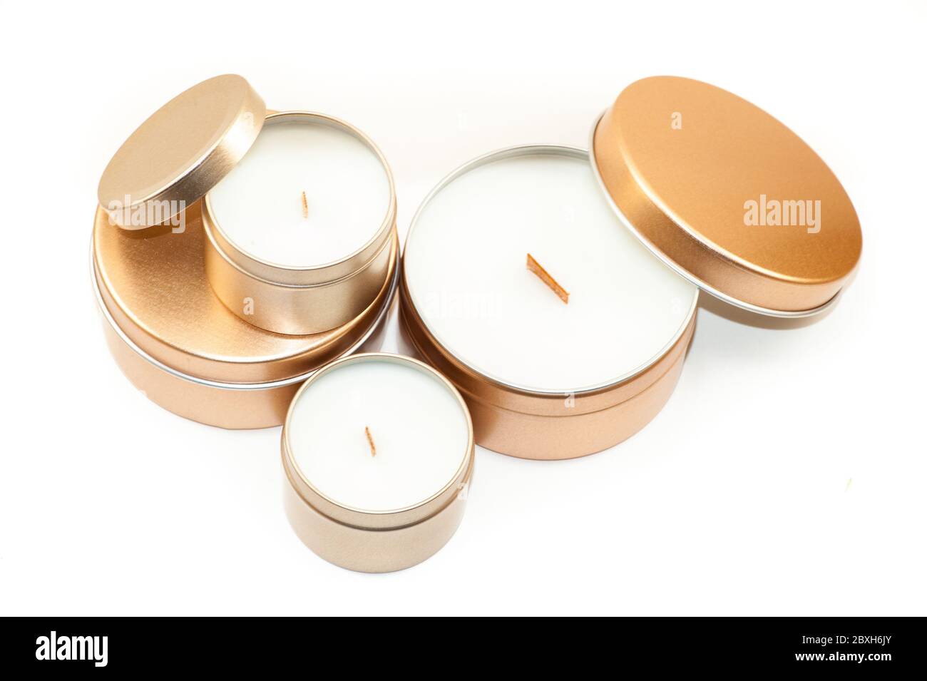 Wooden wick candles in metal tins on white background Stock Photo Alamy
