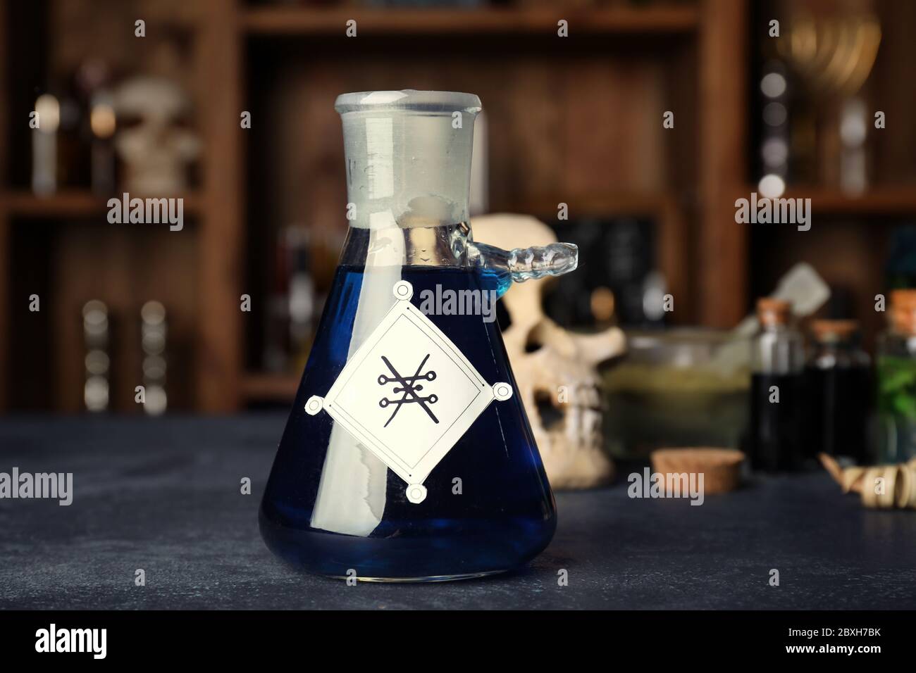 Bottle of potion on alchemist's table Stock Photo