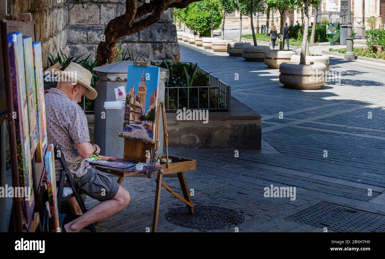 Selective focus on a street painter on a sunny day Stock Photo