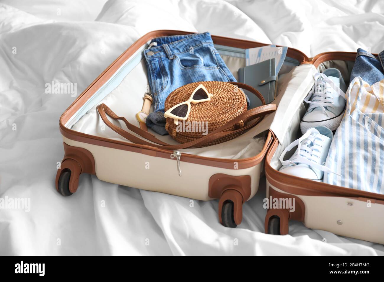 Open packed suitcase on bed Stock Photo Alamy