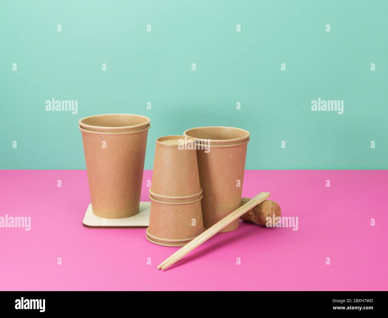 Paper Cups Wooden Coaster For Hot Dishes Sushi Sticks And Cork Kitchen Accessories On Pink And Turquoise Background Stock Photo Alamy