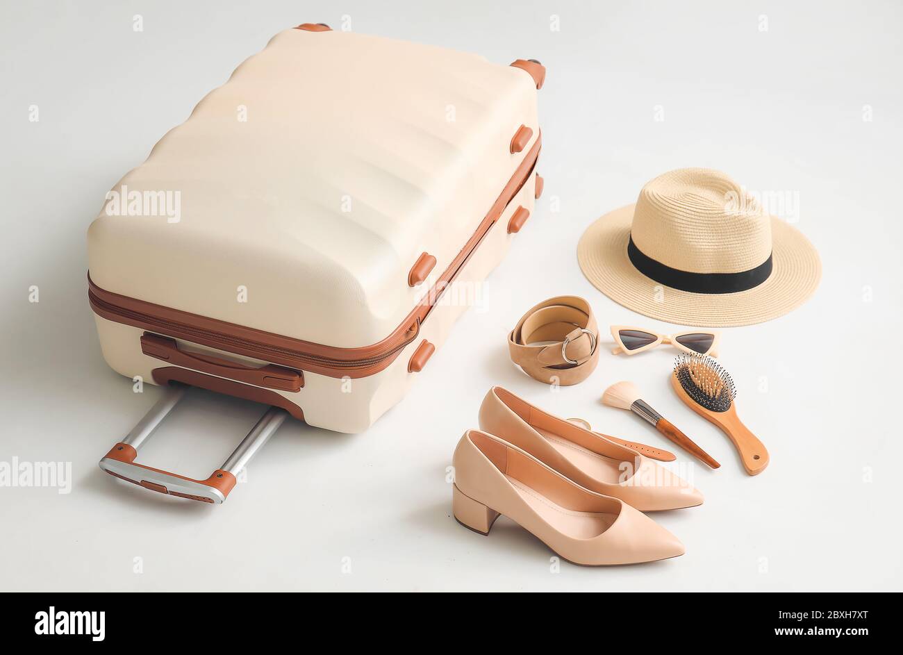 Packed suitcase and accessories on white background Stock Photo