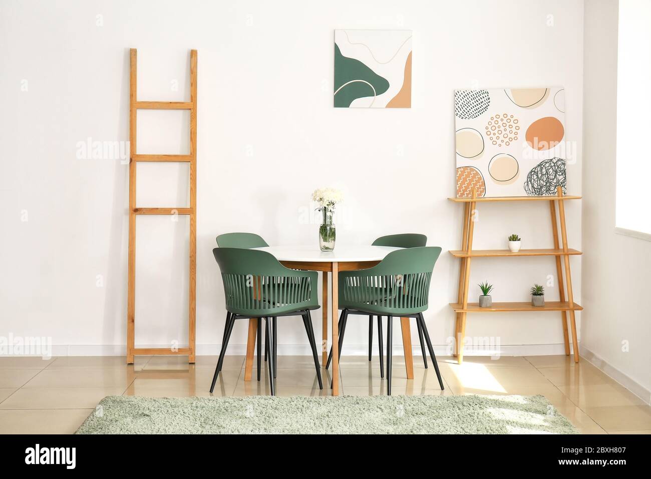Interior of modern living room with table and chairs Stock Photo - Alamy