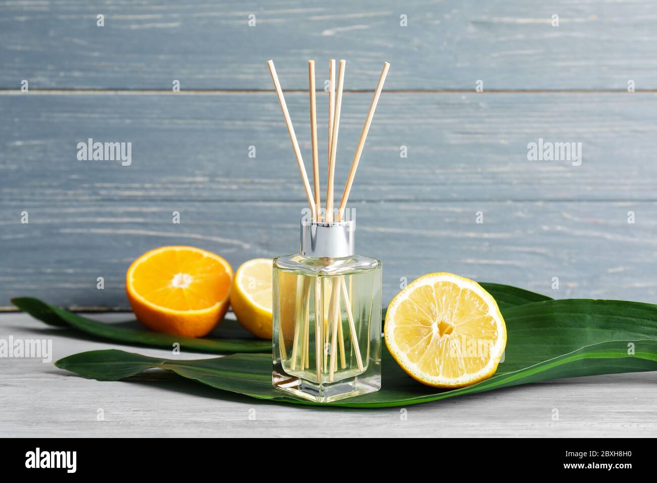 Citrus reed diffuser on wooden table Stock Photo