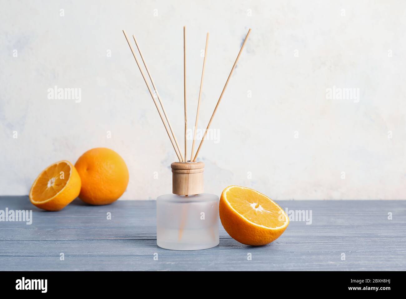 Citrus reed diffuser on wooden table Stock Photo