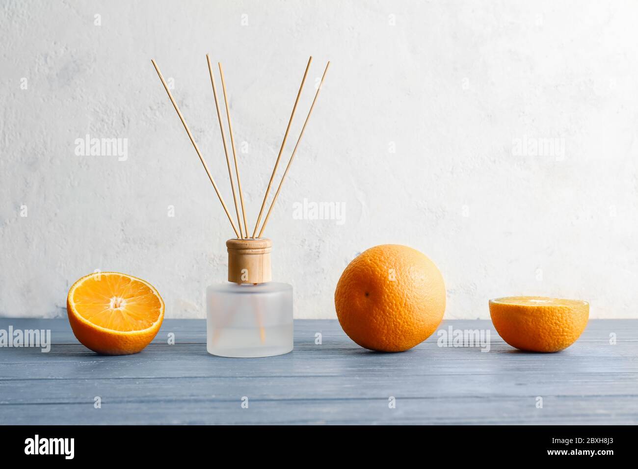 Citrus reed diffuser on wooden table Stock Photo