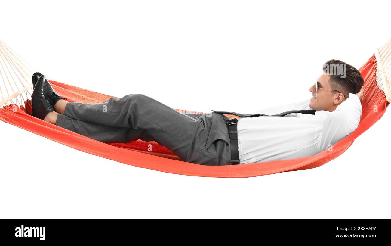 Young businessman relaxing in hammock against white background Stock Photo