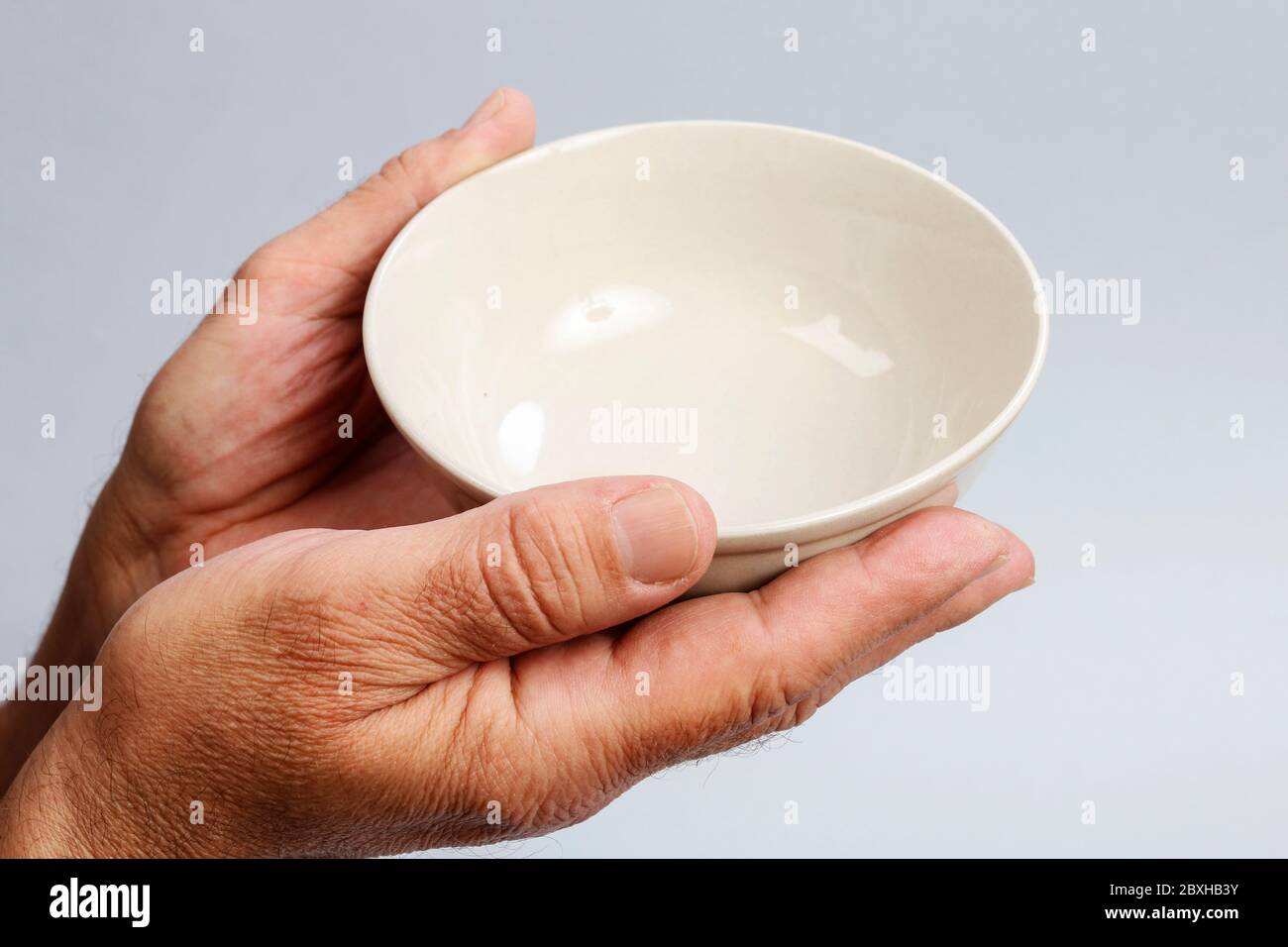 Man holds an empty bowl in his hands. Help needed Stock Photo