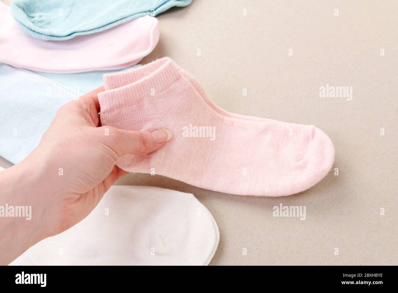 The woman arranges the washed socks. Clothing time Stock Photo