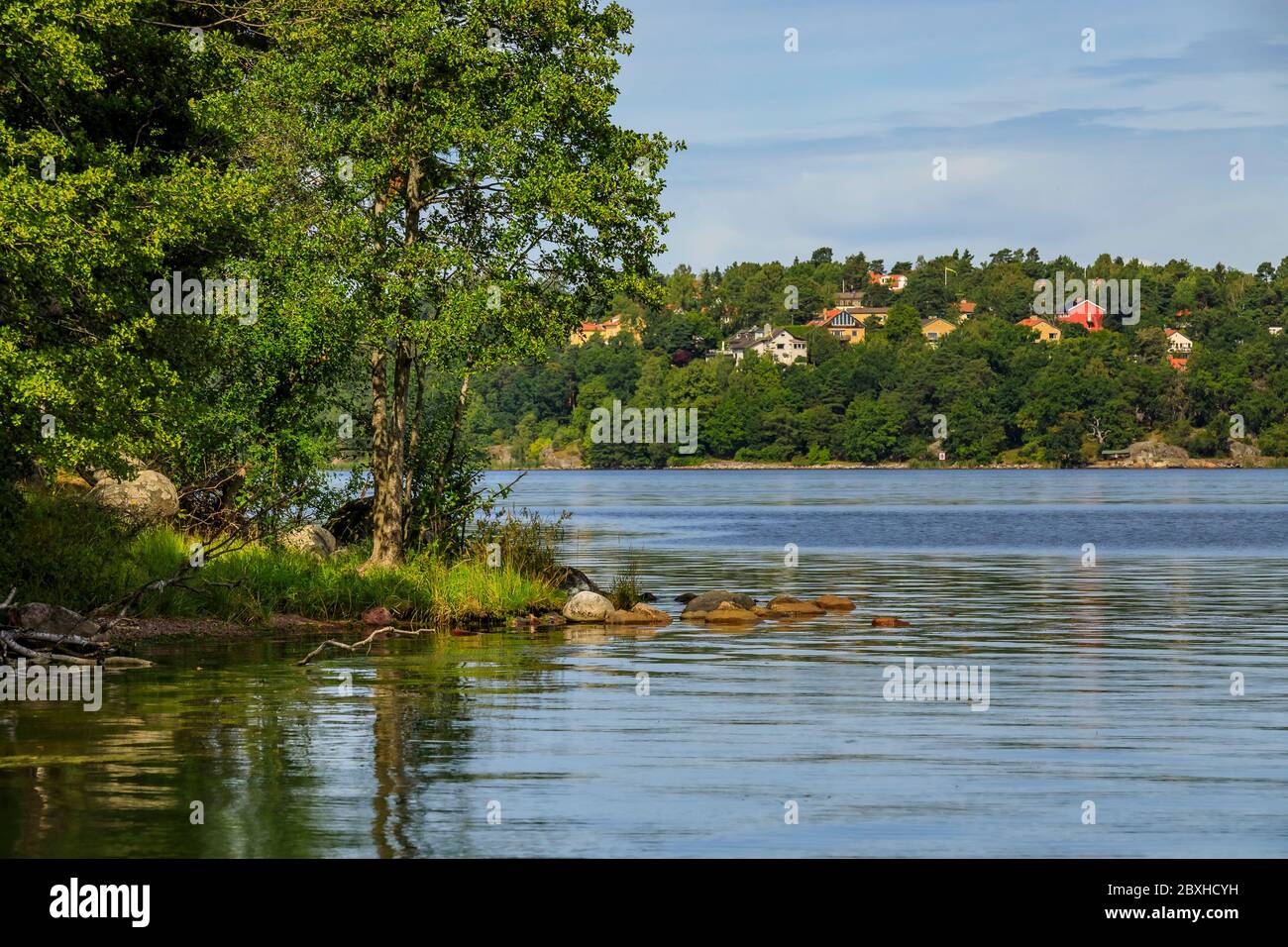View across Lilla Vartan strait onto the shoreline of Stockholm suburbs