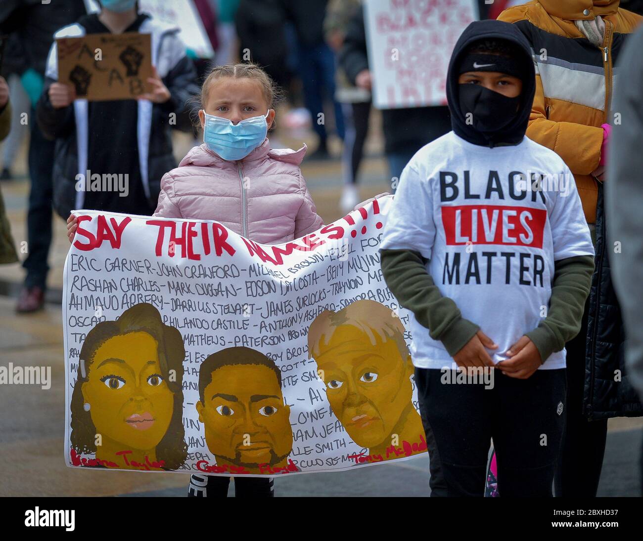 Children hold banners during a Justice for George Floyd rally in Guildhall Square, Londonderry, Northern Ireland. ©George Sweeney / Alamy Stock Photo Stock Photo