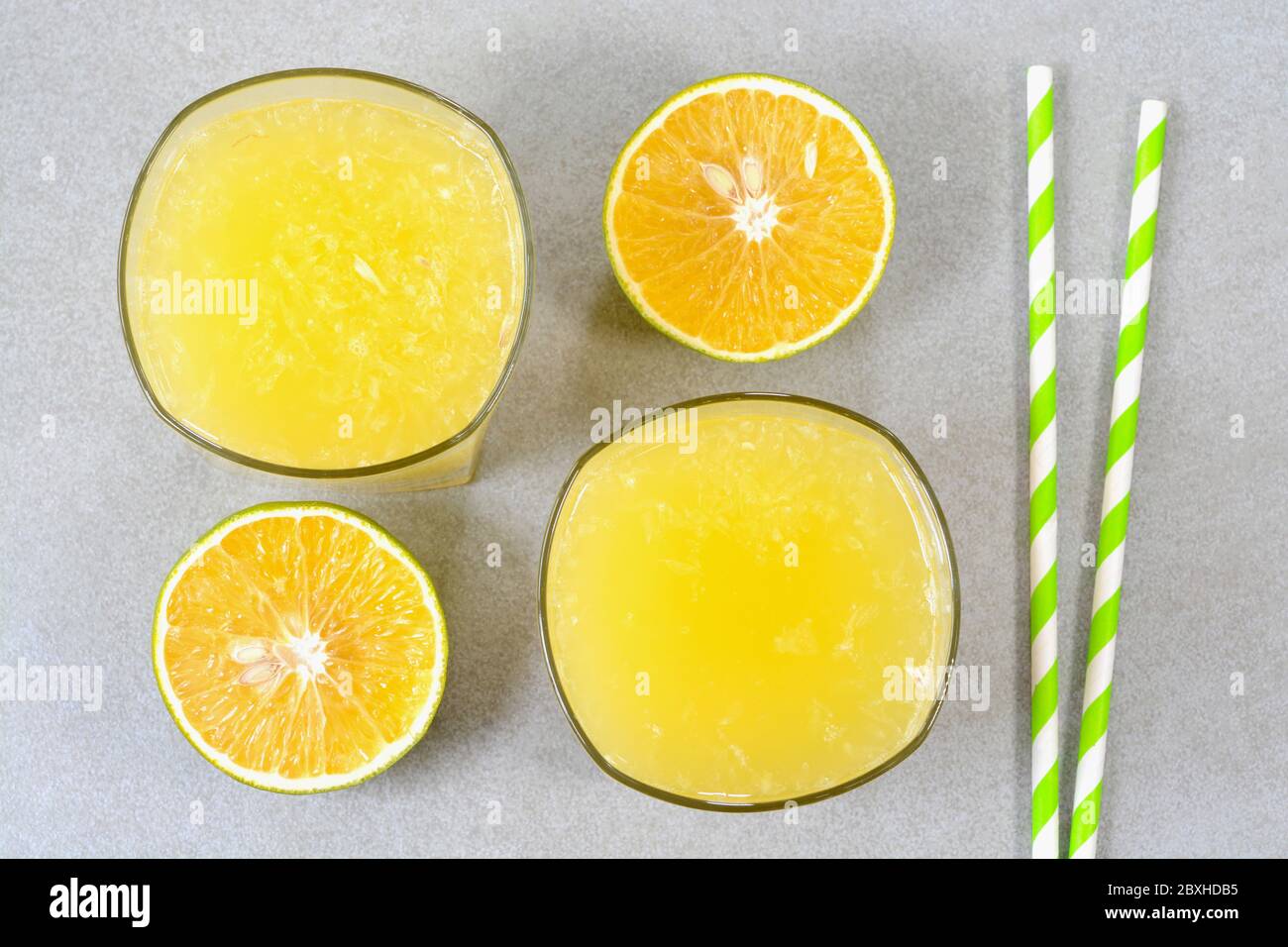 Sweet lime juice in glass cups with sweet lime fruits in the background Stock Photo