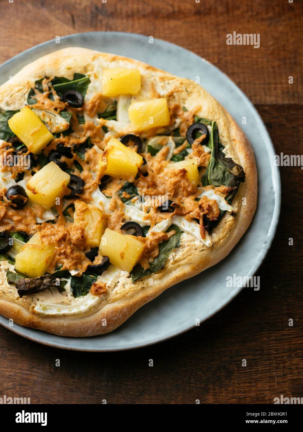 Home made vegan Siberian kale pizza with pineapple and fennel. Stock Photo
