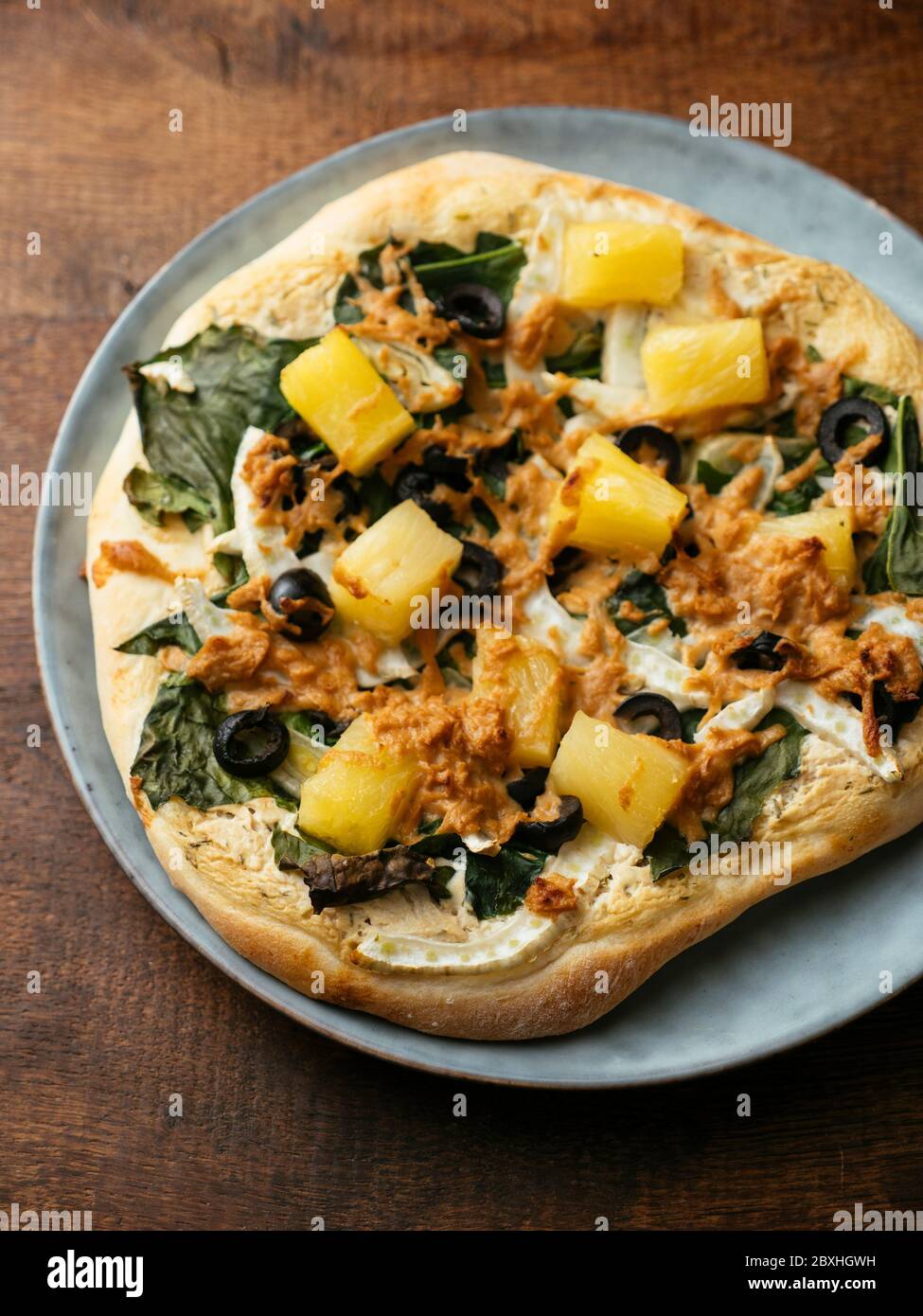 Home made vegan Siberian kale pizza with pineapple and fennel. Stock Photo