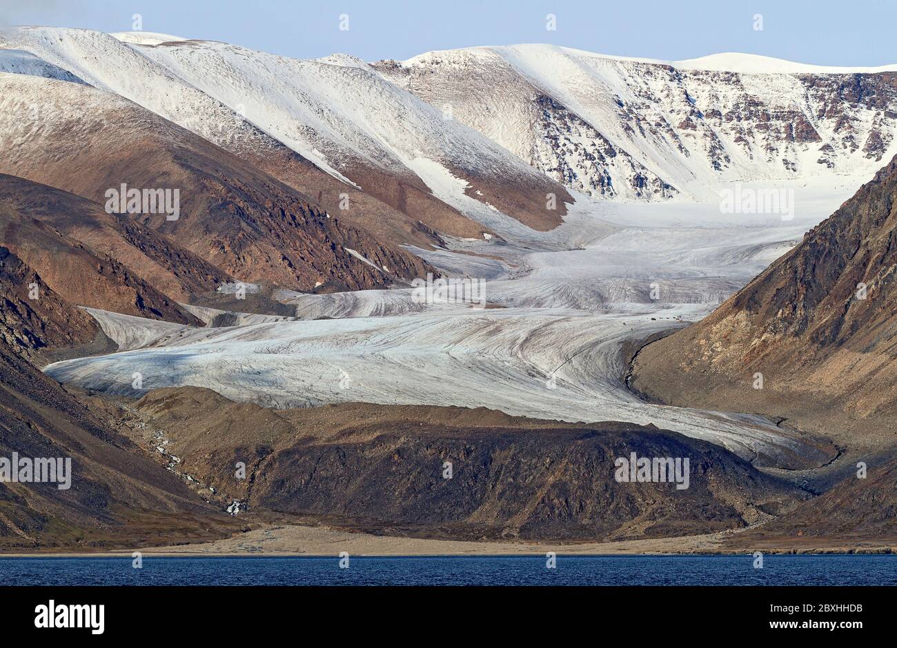 Glaciers (rivers of ice) flowing from the ice cap to the ocean off Devon Island, the largest uninhabited island on Earth. Stock Photo