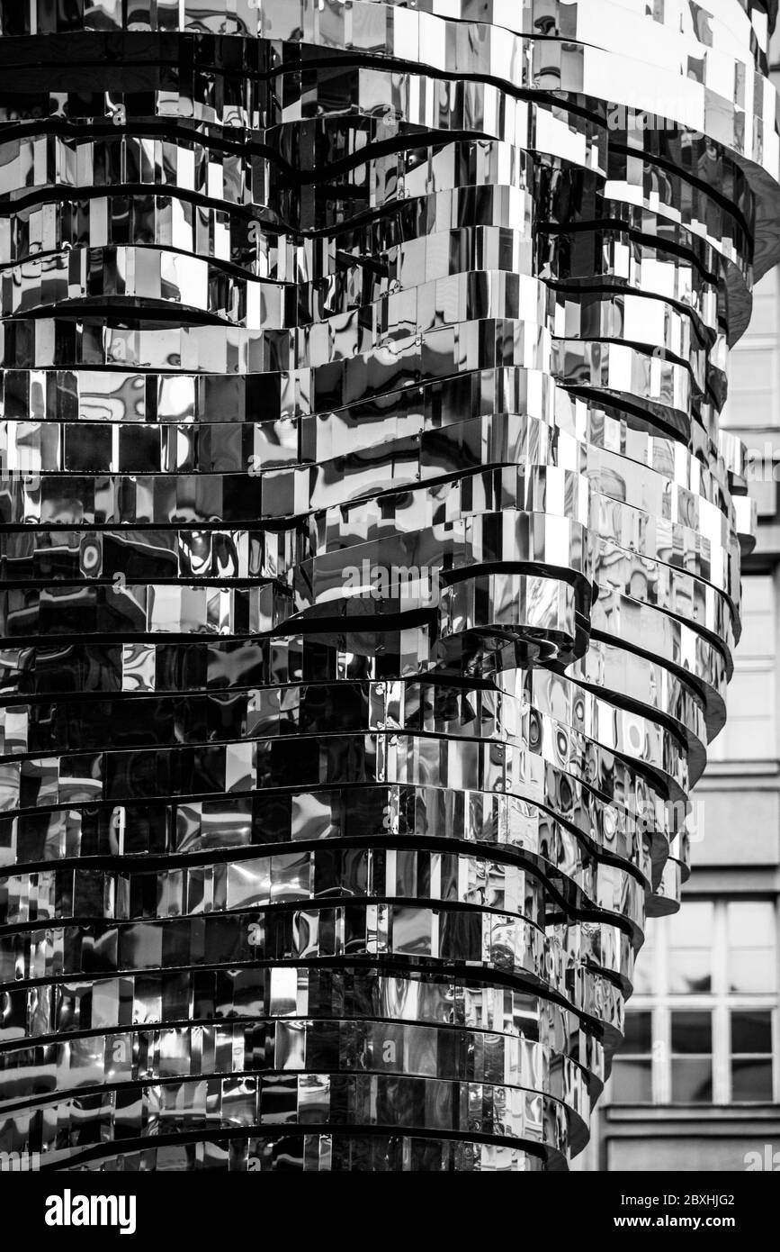 PRAGUE, CZECH REPUBLIC - AUGUST 17, 2018: Statue of Franz Kafka. Glossy metal mechanical sculpture of famous Czech writer. Bust by artist David Cerny. Prague, Czech Republic. Black and white image. Stock Photo