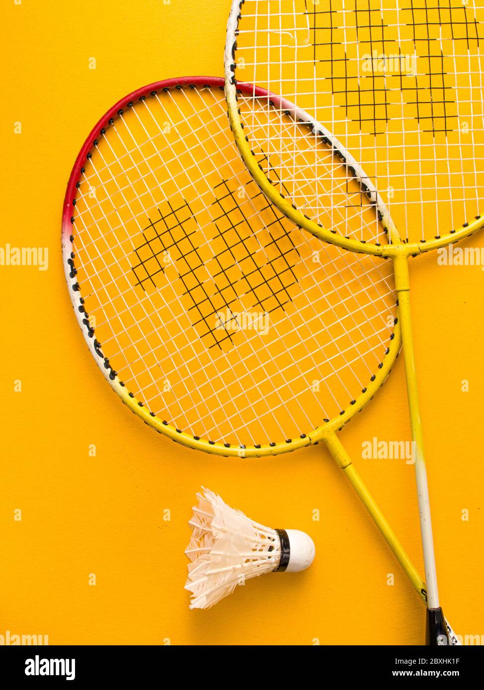 Badminton racket and White Feather Shuttlecock with a colour green  background stock isolated image Stock Photo - Alamy