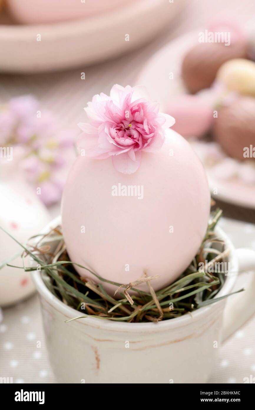 Easter egg in ceramic cup. Simple table decoration. Festive time Stock Photo