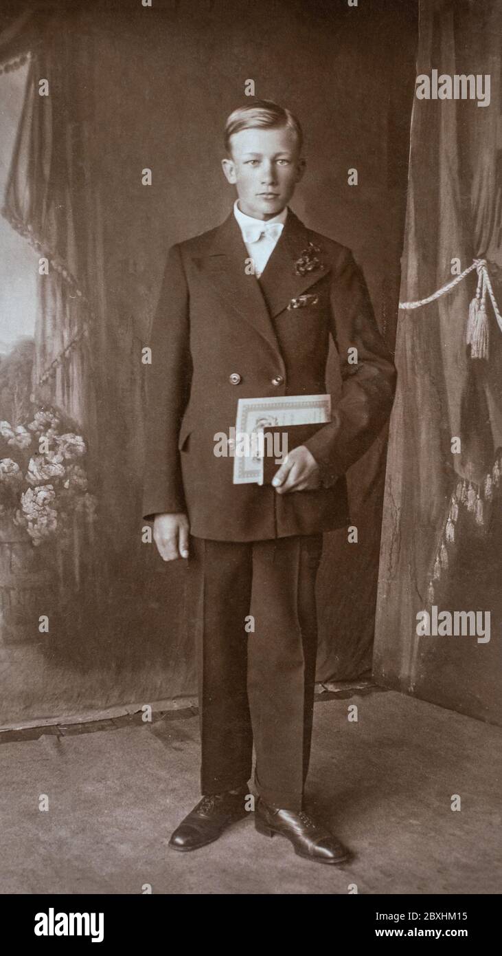 Germany - CIRCA 1920s: Man portrait standing in studio Vintage Carte de Viste art deco era college graduation photo Stock Photo