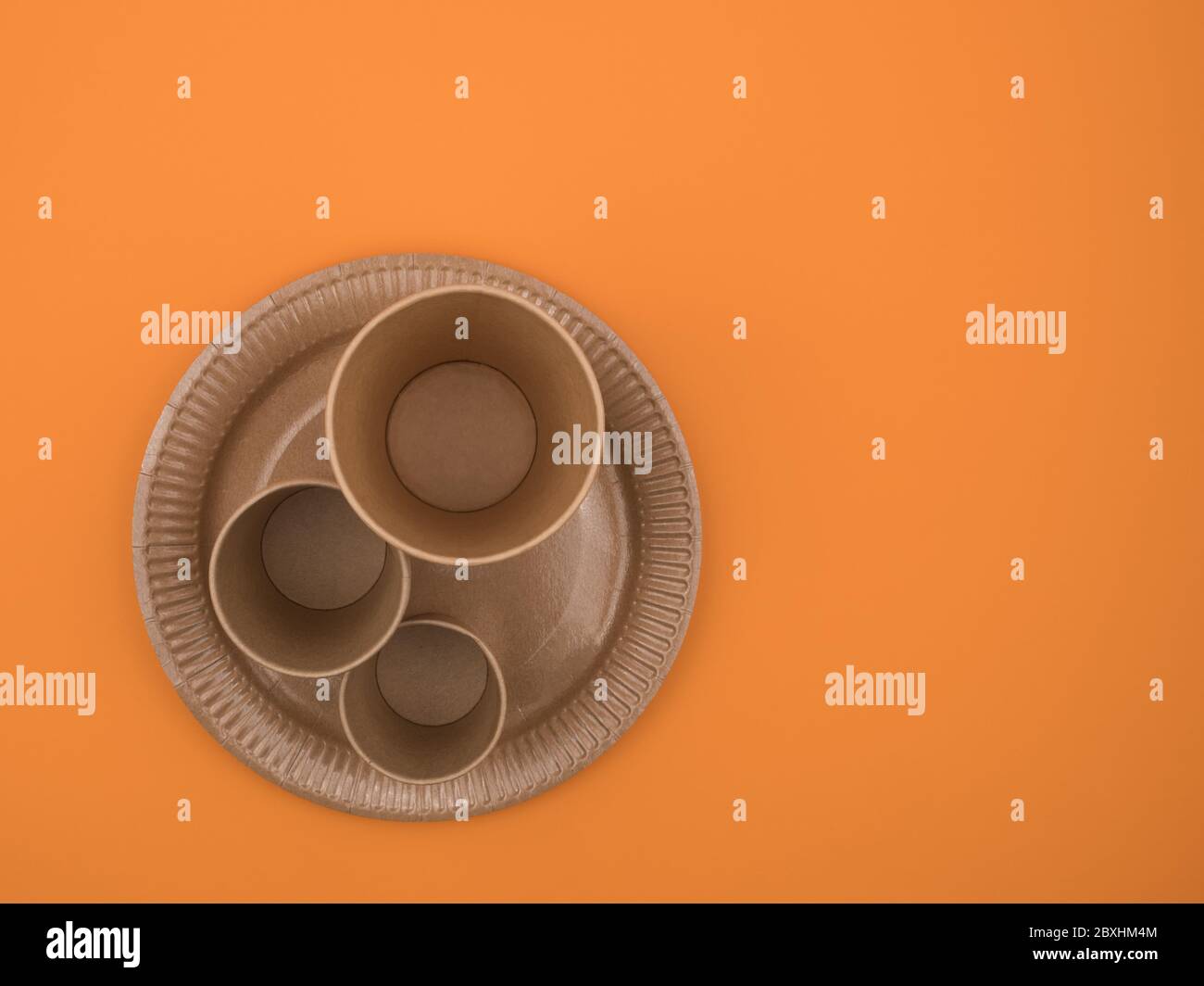 Disposable tableware of paper on orange background Stock Photo Alamy