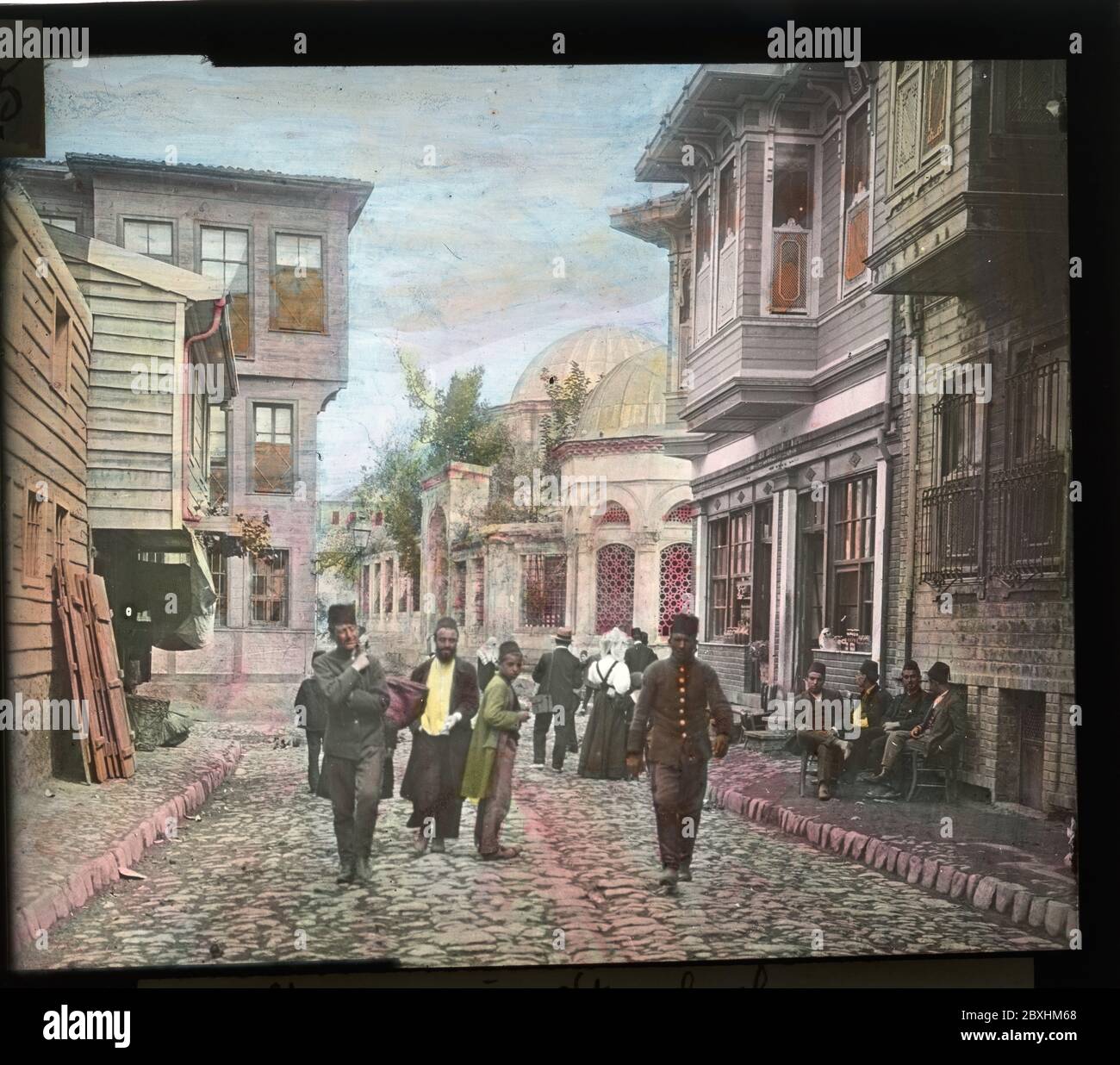 Street in Istanbul with local people and European tourists. Hand colored slide from around 1910. Photograph on dry glass plate from the Herry W. Schaefer collection. Stock Photo