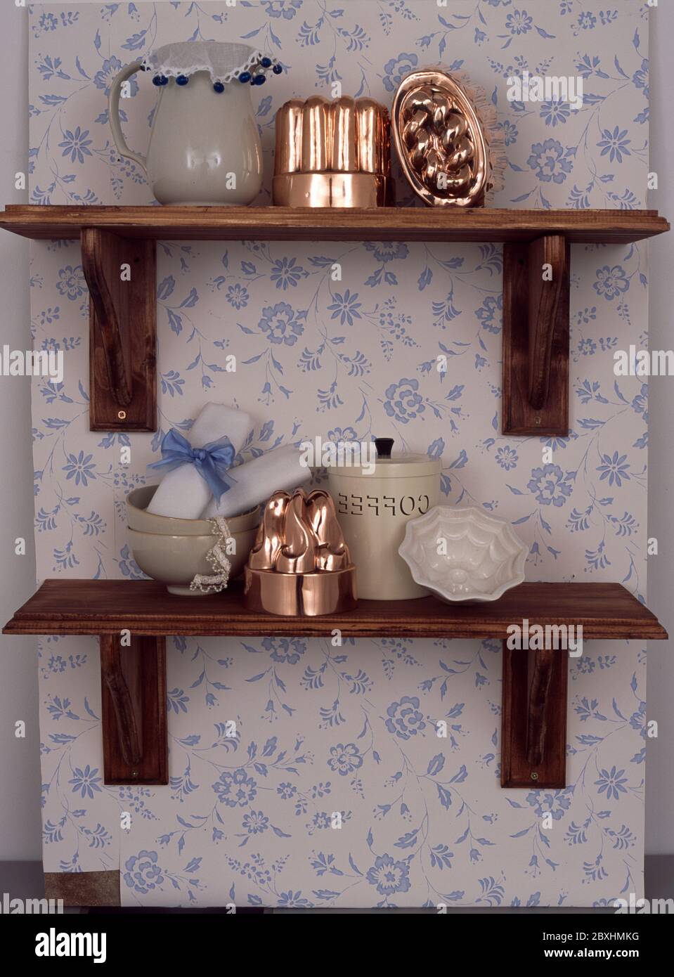 Wall hung shelves displaying kitchen objects Stock Photo