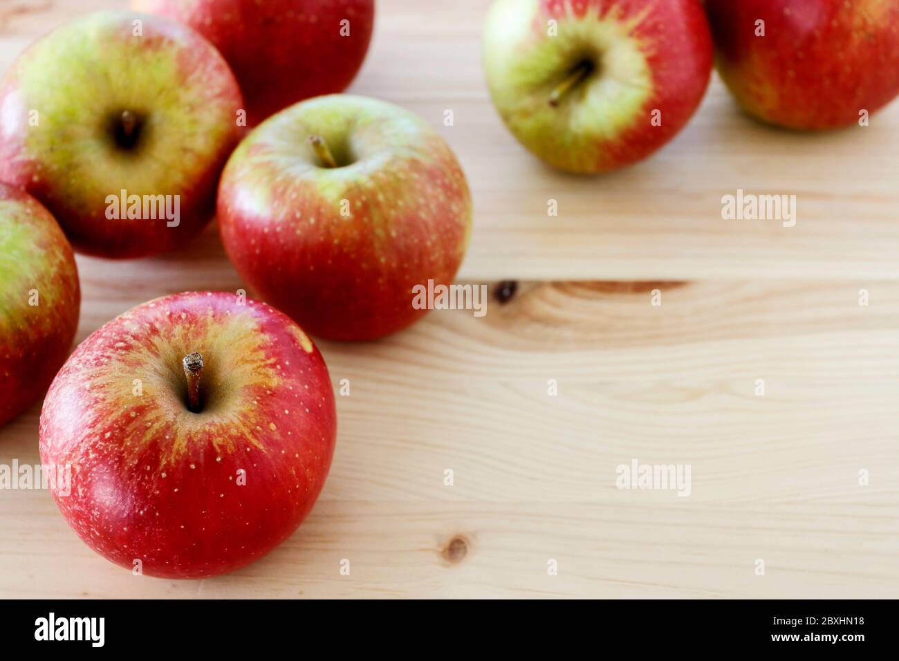 Red and yellow apples on wooden table. Healthy food Stock Photo