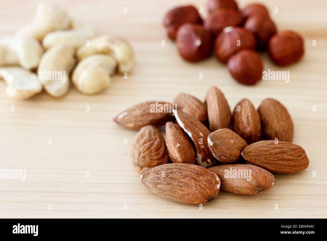 Various nuts on wooden table. Stock Photo