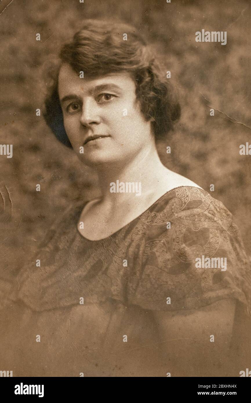 Latvia - CIRCA 1924: Portrait of female in studio, Vintage Carte de Viste Art Deco era photo Stock Photo