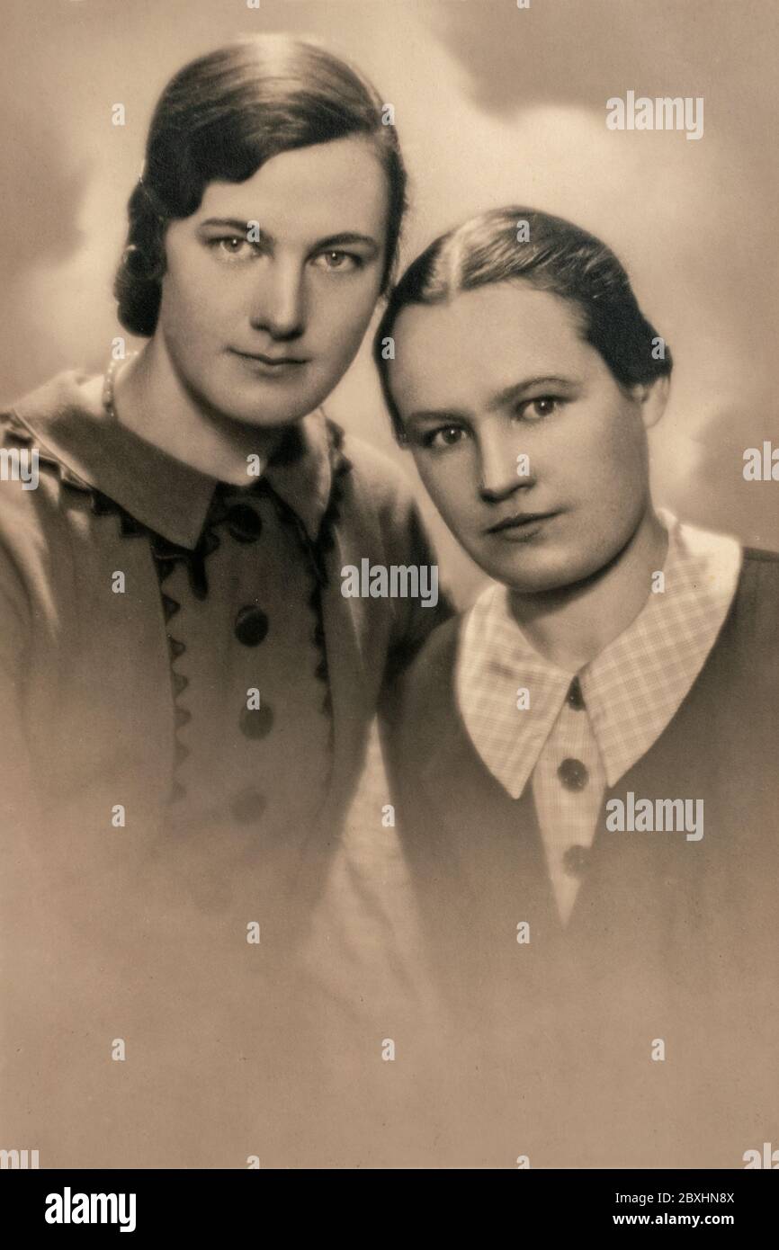 Latvia - CIRCA 1930s: Close up portrait of two woman in studio, Vintage Art Deco era photo Stock Photo