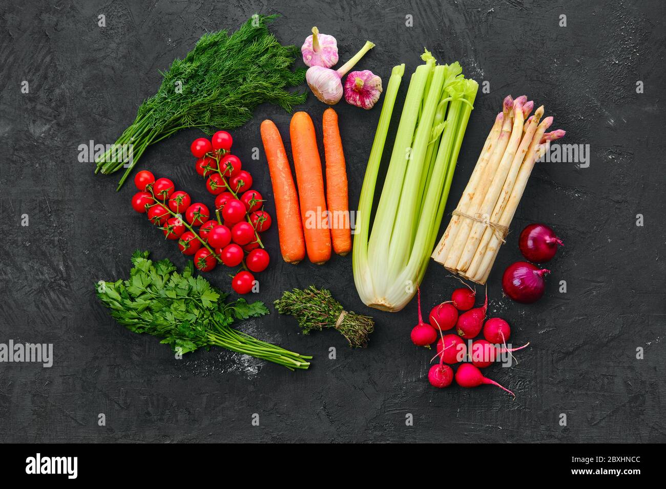 Top view of fresh raw vegetables on black background Stock Photo - Alamy