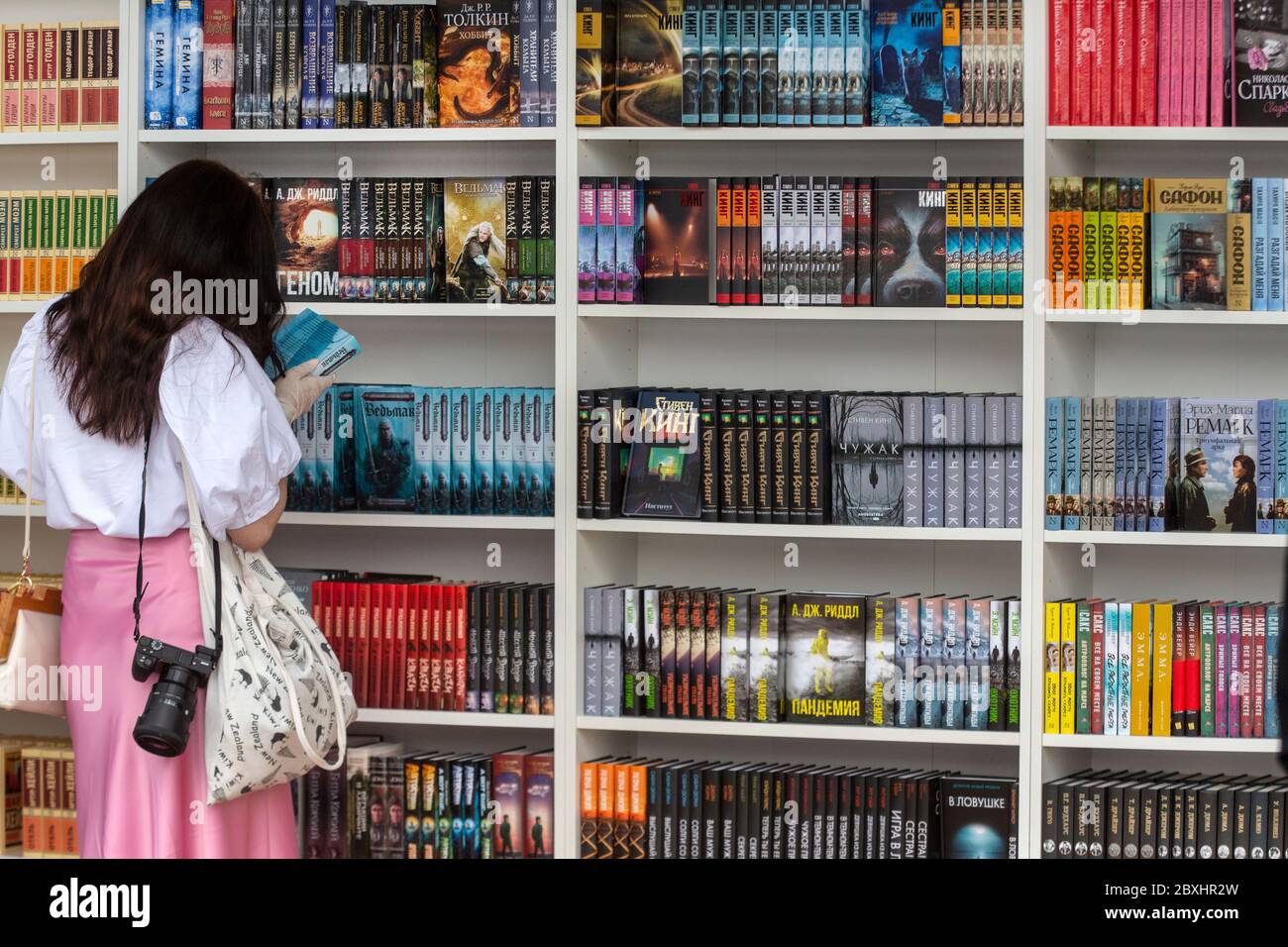 Moscow, Russia. 6th of June, 2020 A woman looks books at a site of the annual Red Square book festival in the center of Moscow, Russia Stock Photo