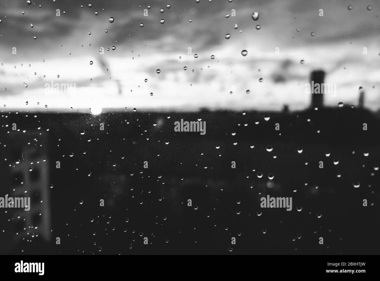 Raindrops on a window pane on a rainy evening Stock Photo