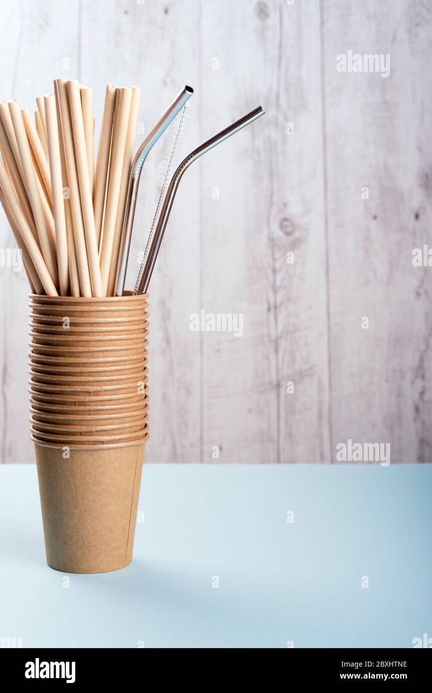 Paper and stainless steel drinking straws are in brown cups.  Stock Photo