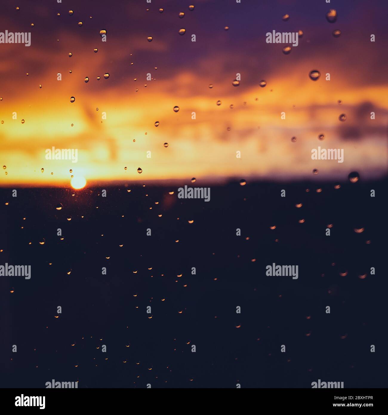 Raindrops on a window pane on a rainy evening Stock Photo