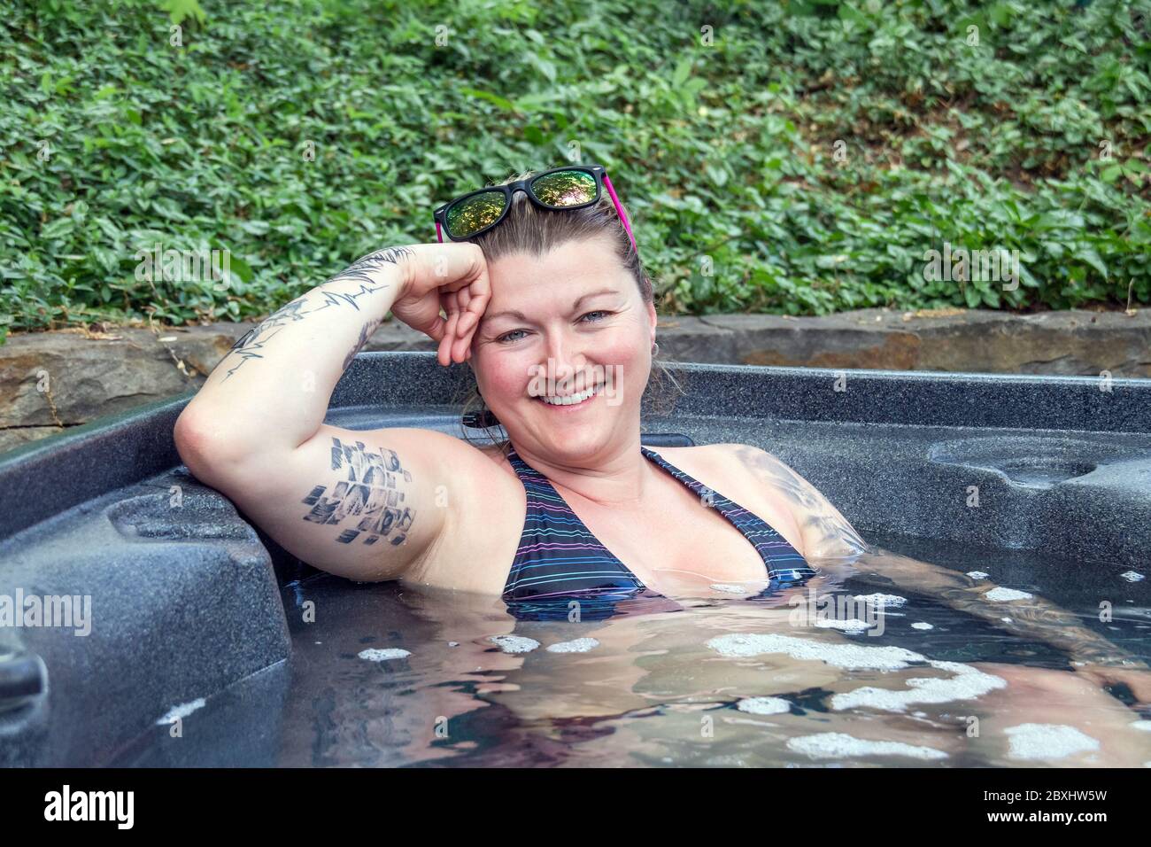 caucasian woman relaxing in a hot tub outdoor Stock Photo